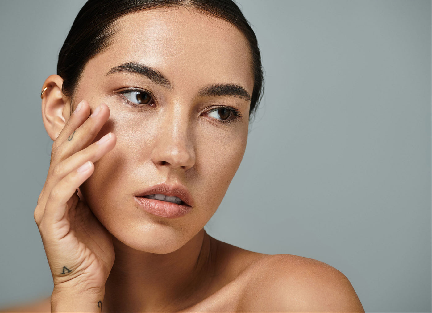 Beauty Shopify Theme Beautify Woman with natural makeup holding hand to face