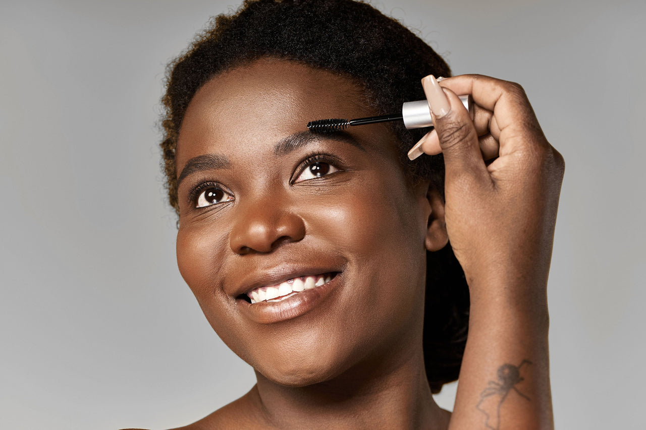 Beauty Shopify Theme Beautify Happy woman applying eyebrow makeup