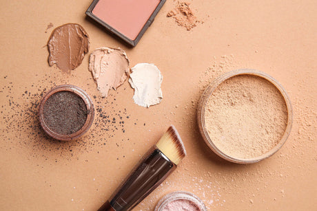 Beauty Shopify Theme Beautify. Makeup products including a brush, powders, and blush on a beige background