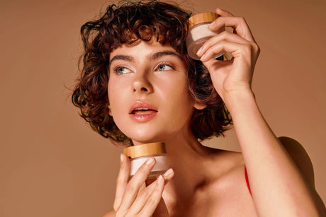 Beauty Shopify Theme BeautifyWoman playfully holding tubs of makeup near face