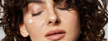 Beauty Shopify Theme Beautify Relaxed woman with curly hair and face cream