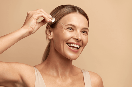 Beauty Shopify Theme Beautify. Woman applying skincare product to her face with a beige background