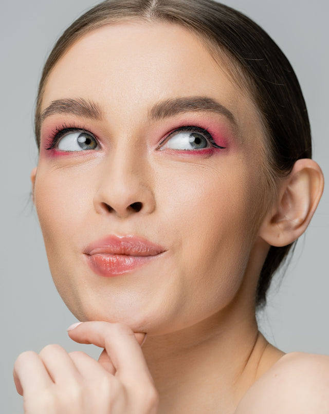 Beauty Shopify Theme Beautify. Close-up of a woman with pink eye makeup and a neutral background