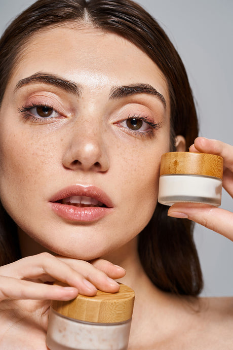 Beauty Shopify Theme Beautify. Woman with dark hair and natural makeup holding tubs of face cream